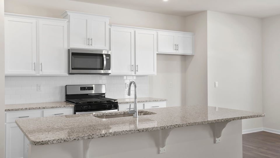 Kitchen and island have quartz countertops.
