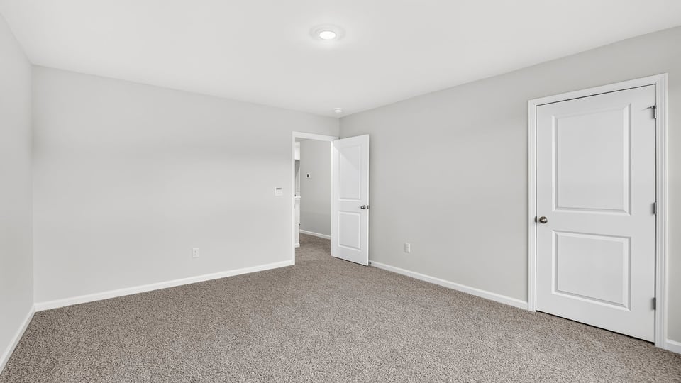 Bedroom with carpet and window.