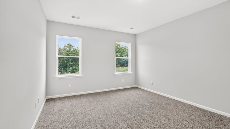 Bedroom with carpet and window.
