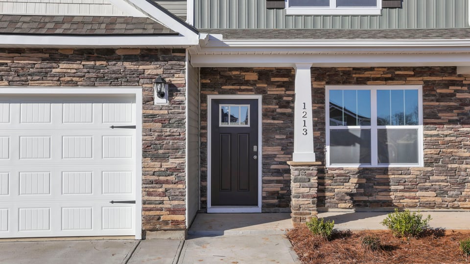 Inviting covered porch with stone accents.