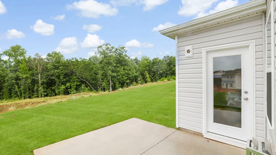 Back exterior of home with patio.