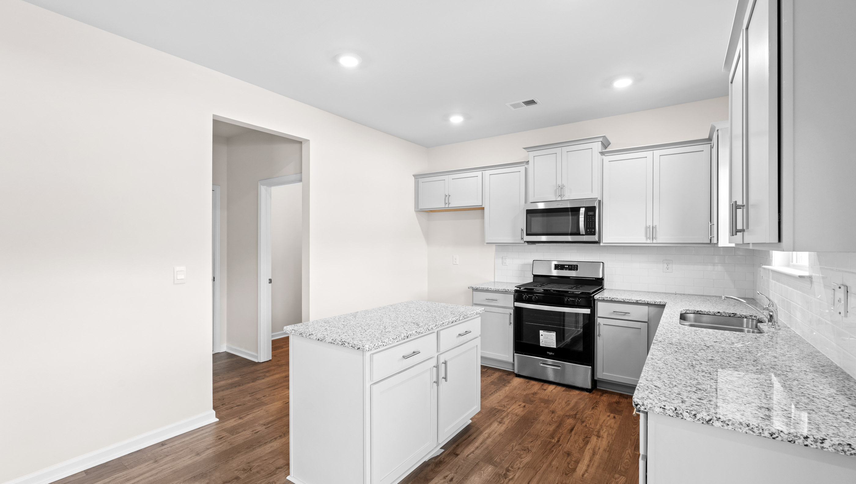 Kitchen and island with granite counter tops.