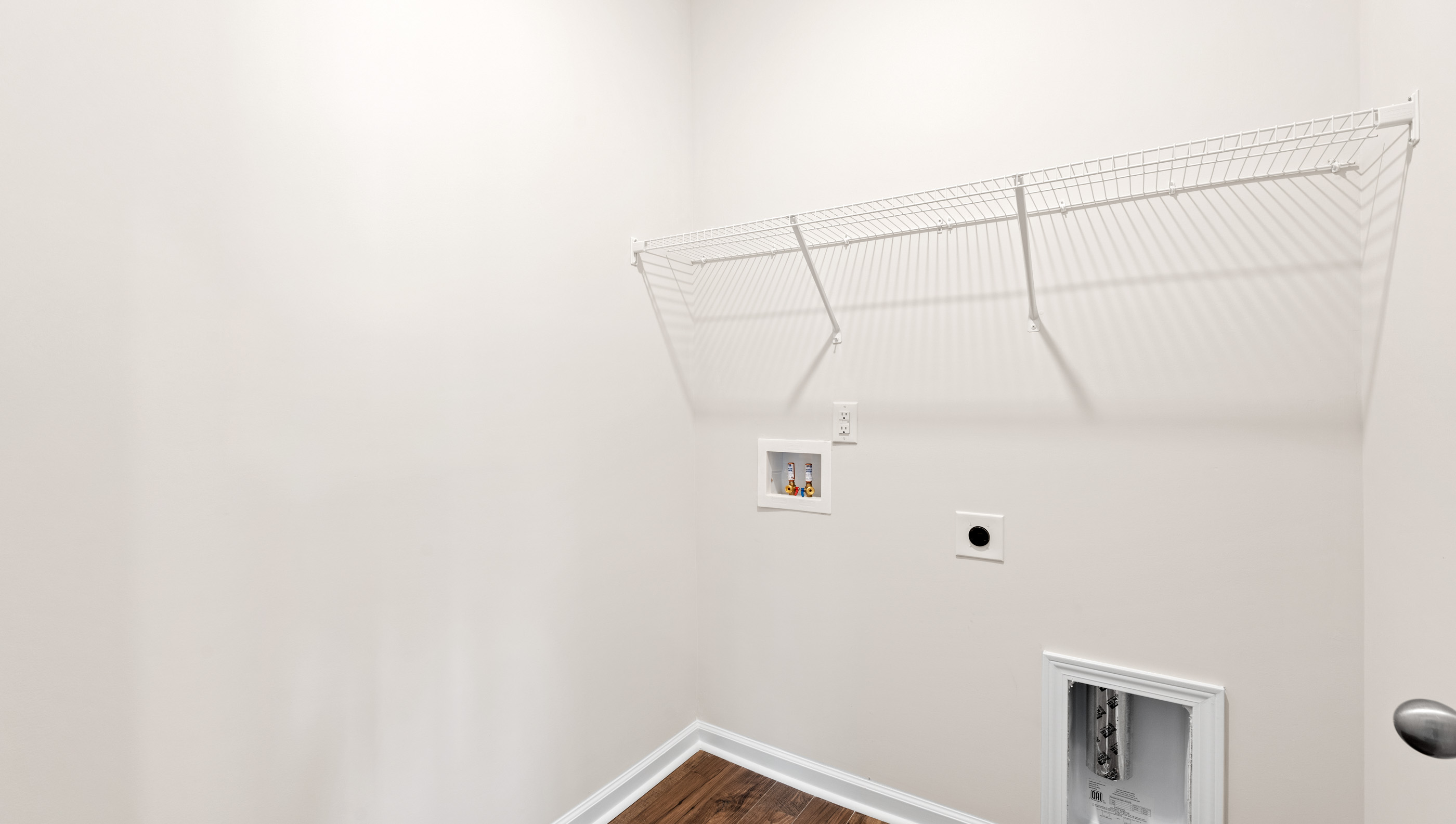 Laundry room with hanging storgae racks.