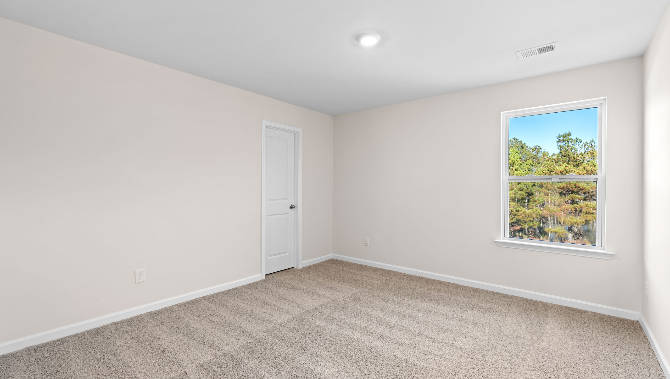 Bedroom with carpet and window.