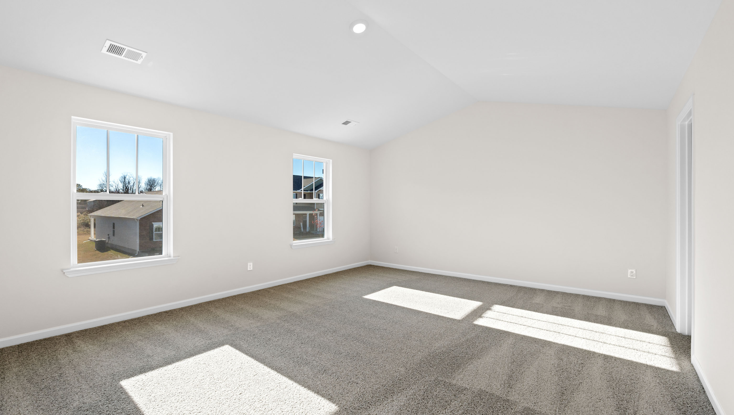 Bedroom with carpet and window.
