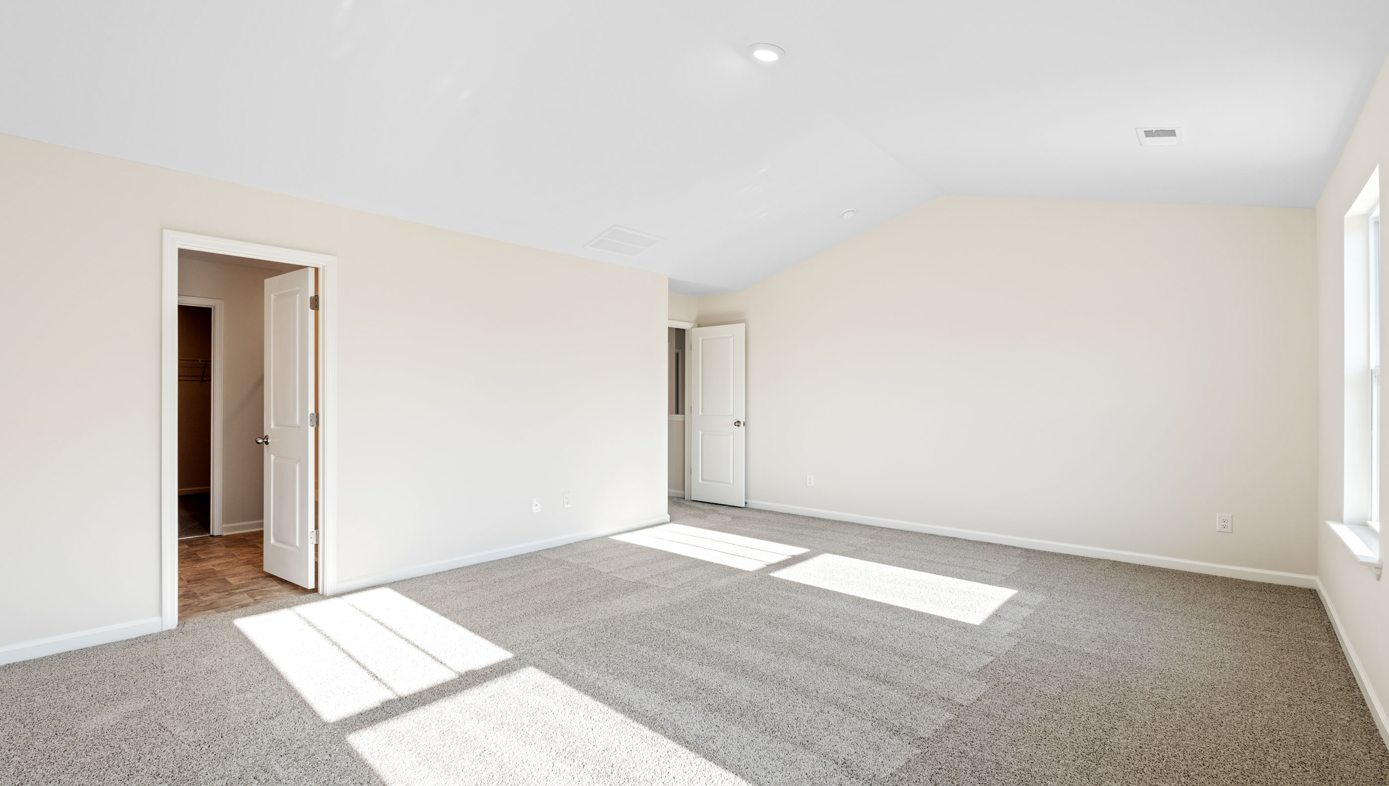 Bedroom with carpet and window.