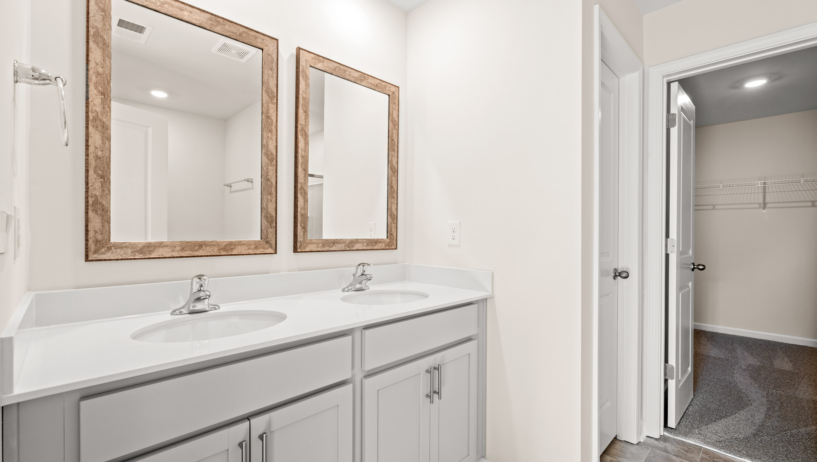 Bathroom with double vanity sink and closet.