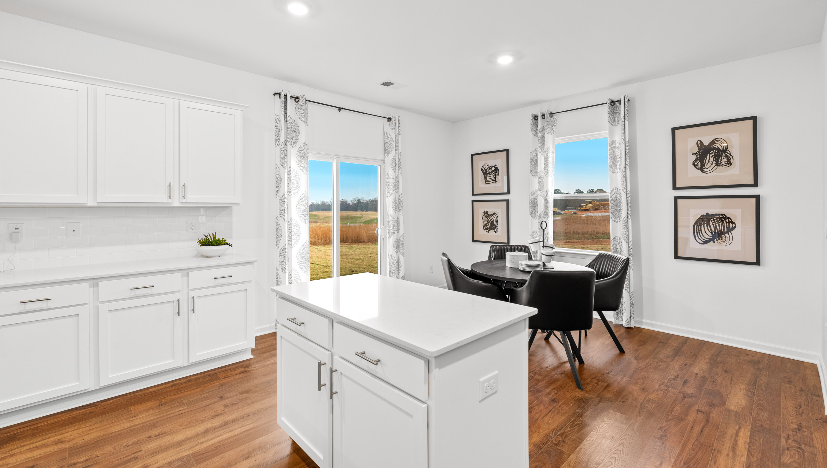 Kitchen and island with stainless steel appliances.