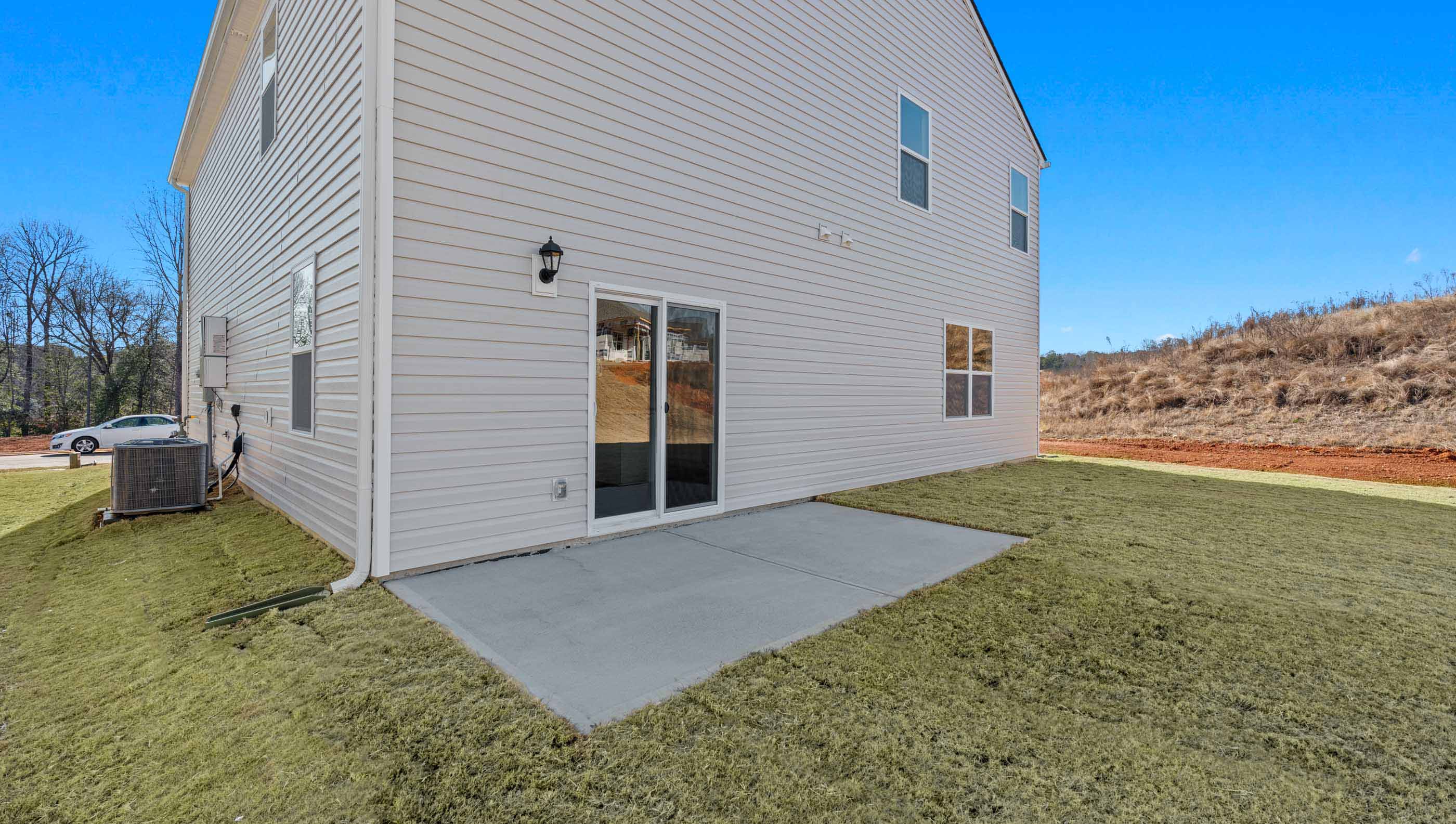 Back exterior of home with patio.