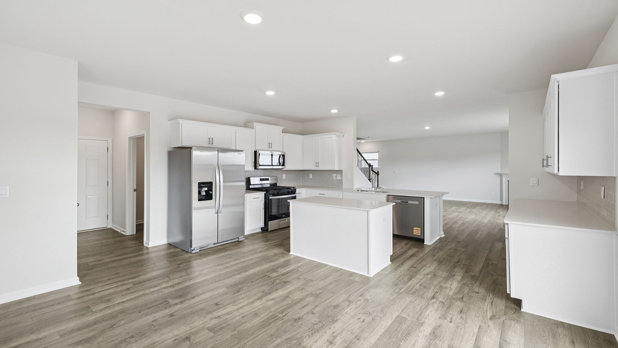 Open kitchen with island and recessed lighting.