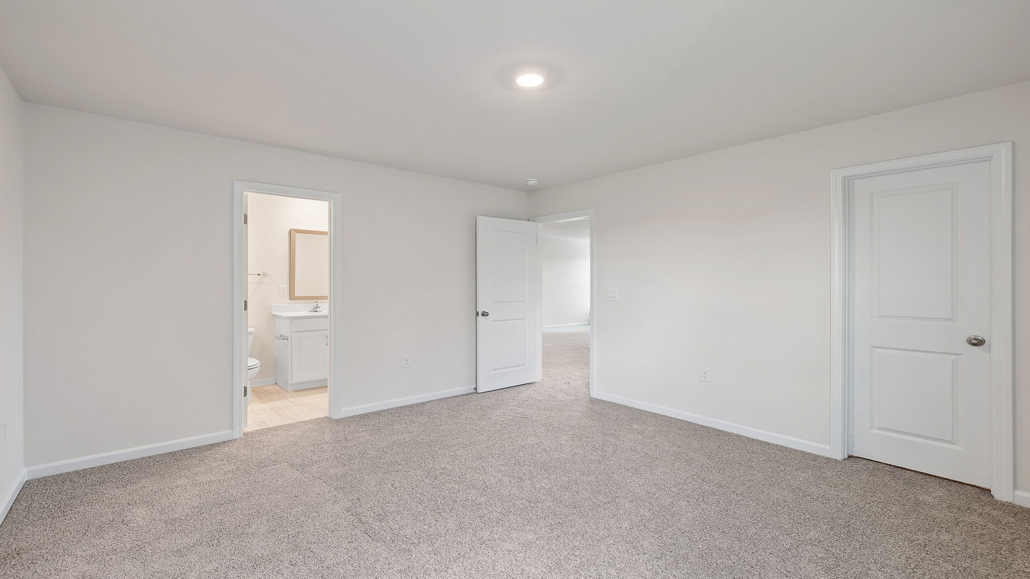 Bedroom with carpet and windows.