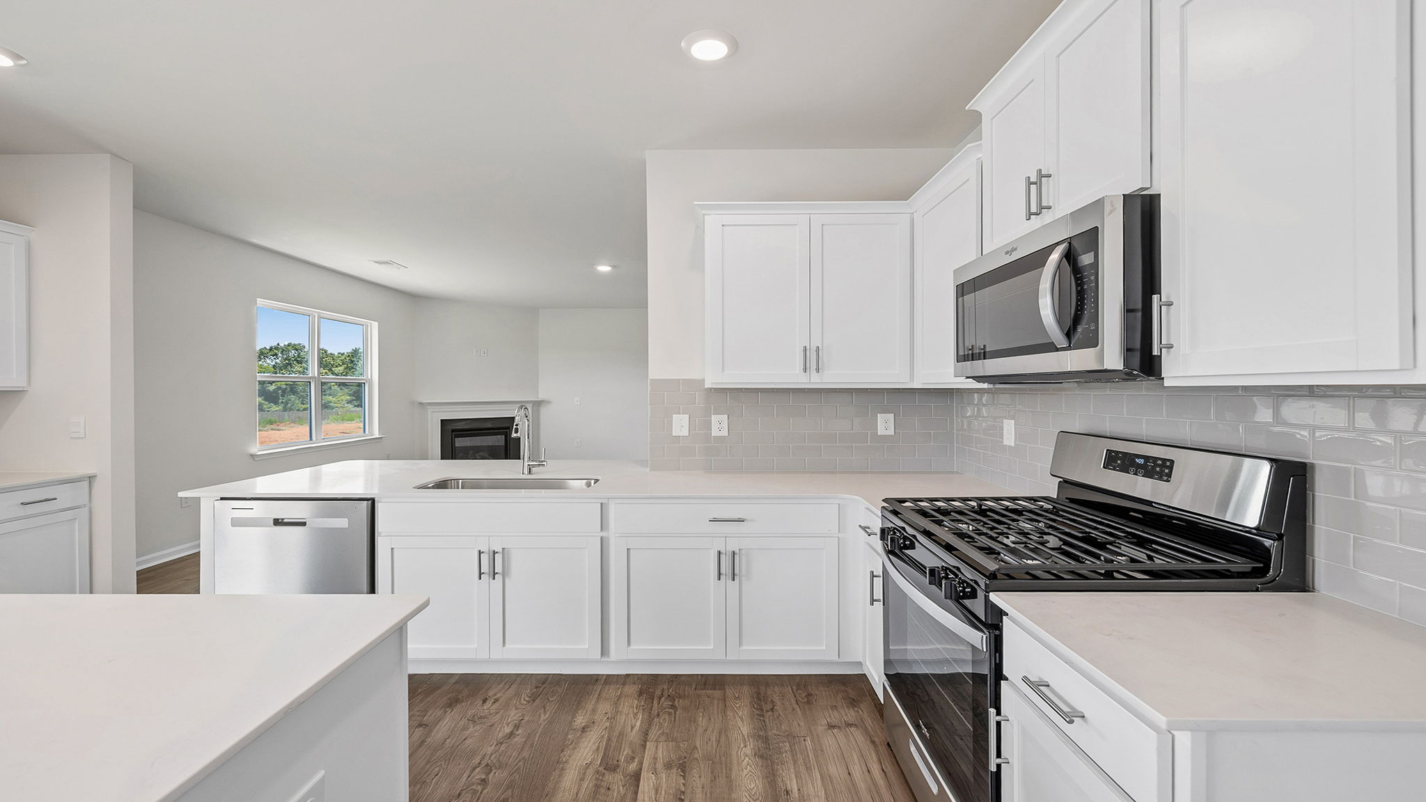 Kitchen and island with stainless steel appliances.