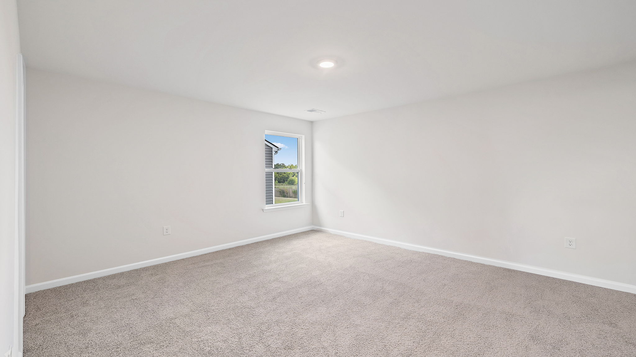 Bedroom with carpet and window.