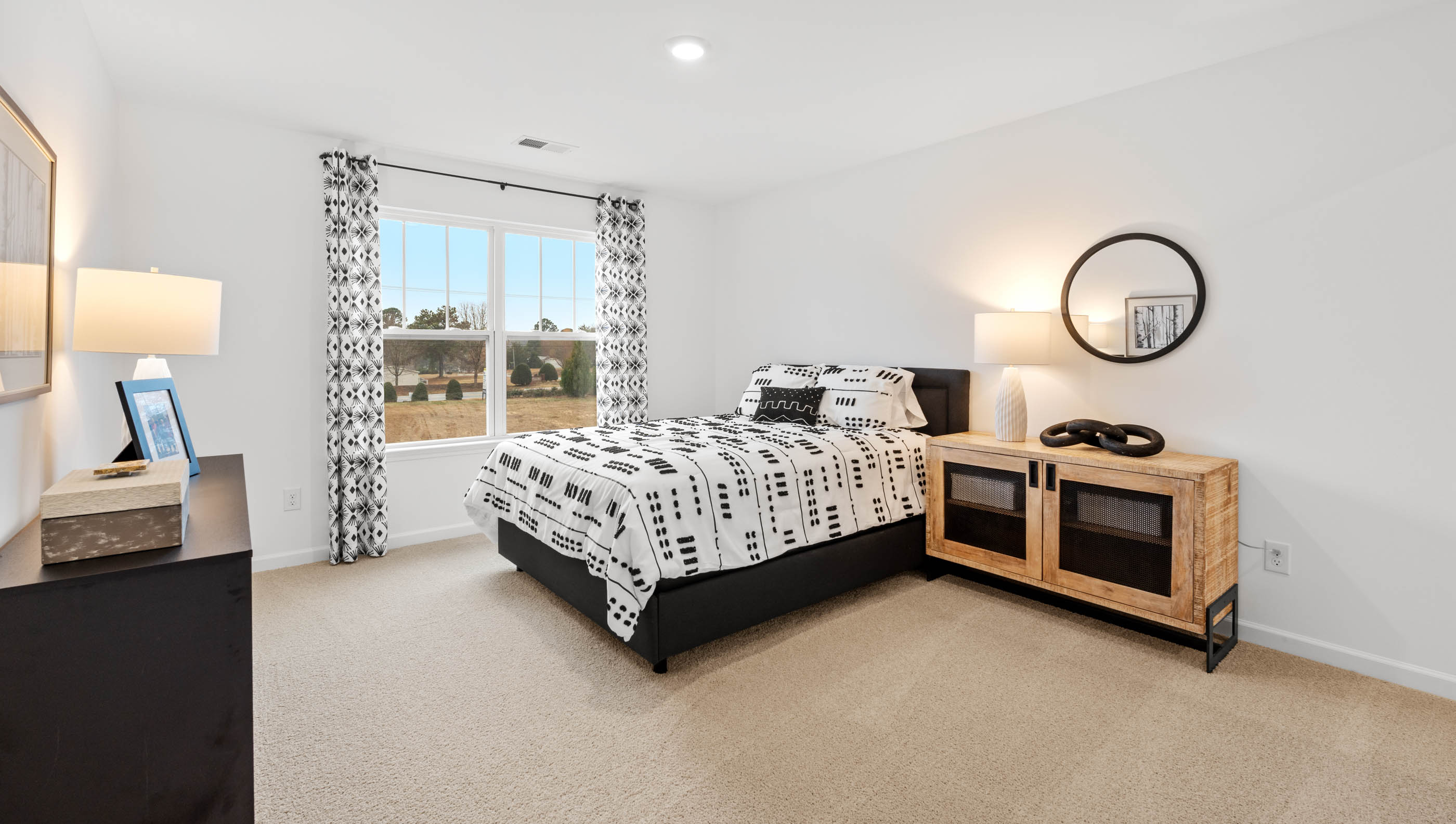 Bedroom with carpet and window.