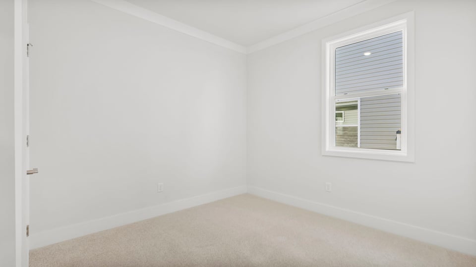 Bedroom with carpet and windows.