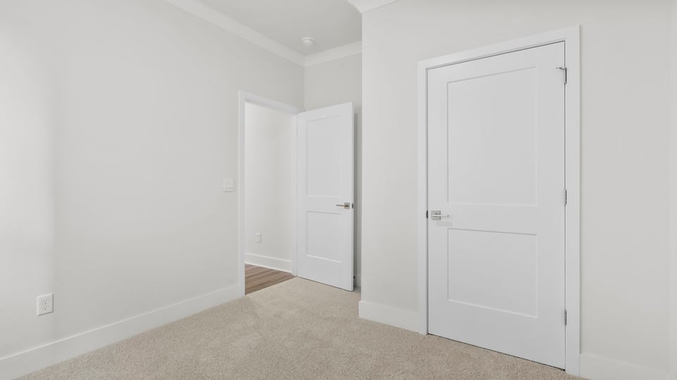 Bedroom with carpet and windows.