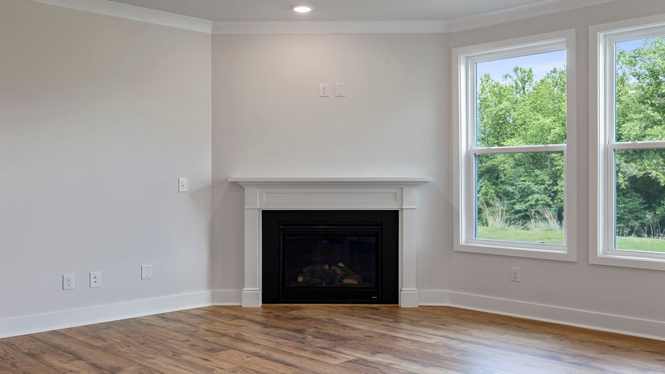 Living room with windows and fireplace.