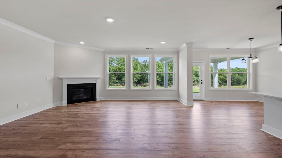 Living room with windows and fireplace.
