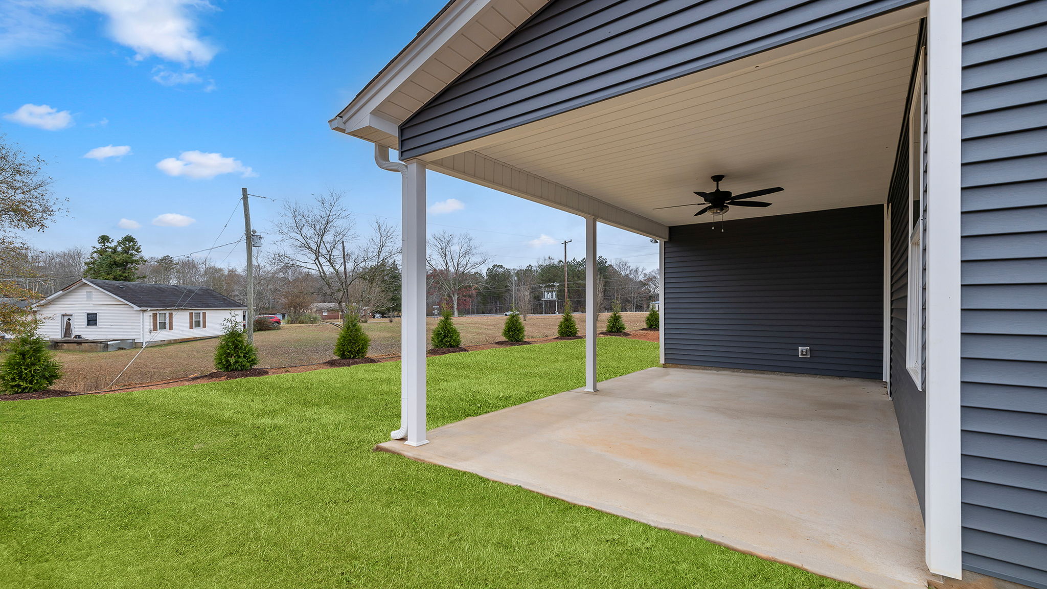 Back exterior with covered patio.