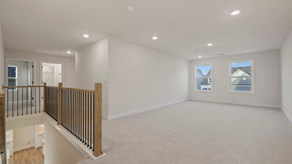 Loft with carpet and windows.