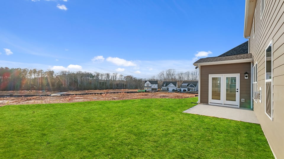 Back exterior with large backyard.