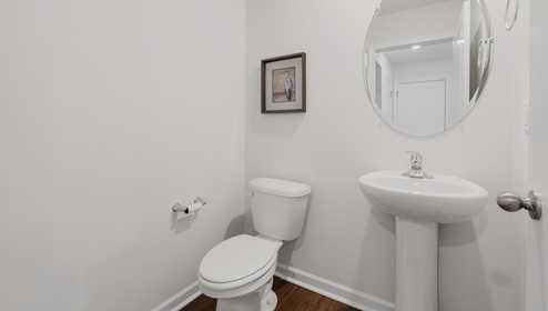 Half bathroom with mirror.