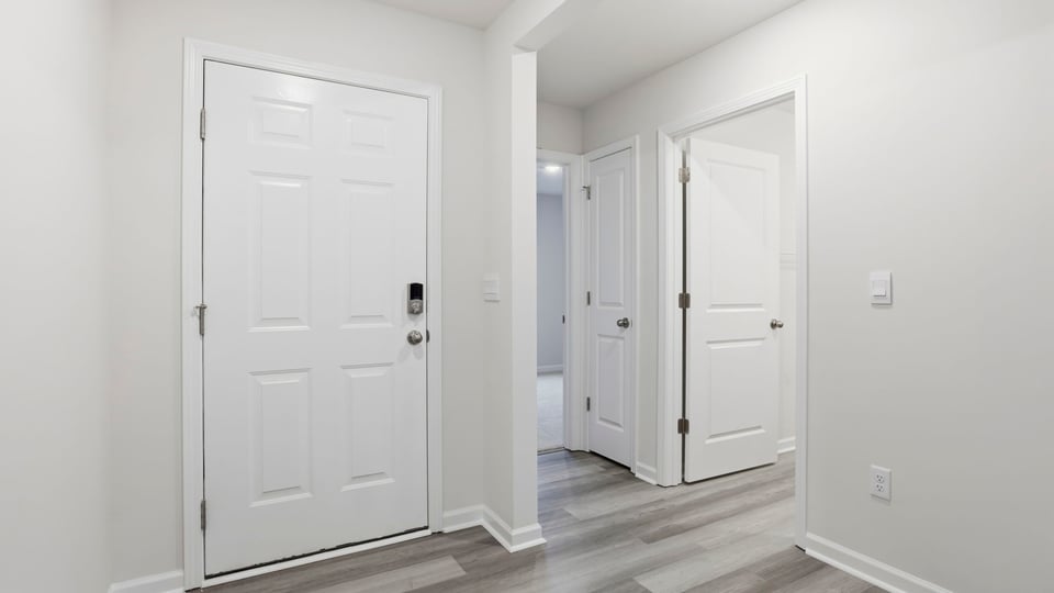 View of entry and doors to the bedrooms.