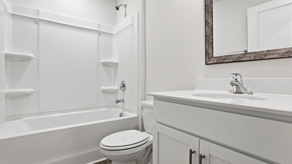 Hall bathroom with vanity and combination shower / tub.