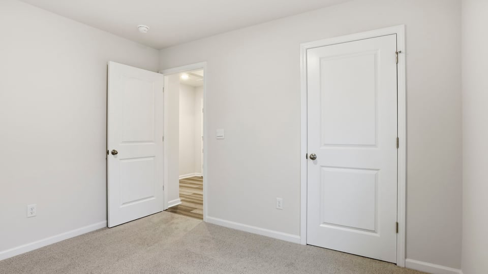 Bedroom with window and carpet.