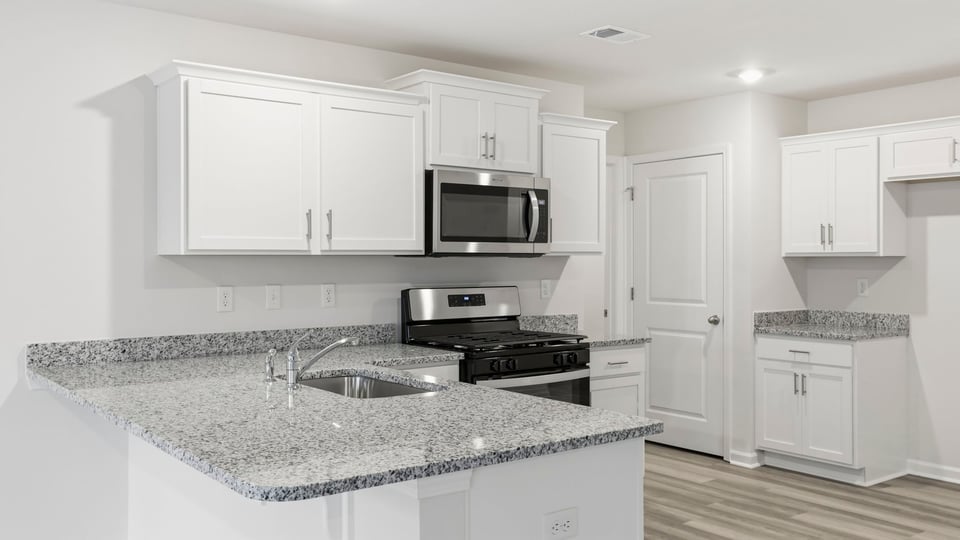 Kitchen has quartz countertops.