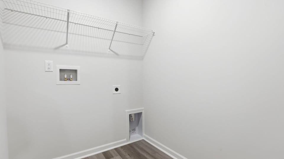 Walk-in laundry room with shelving.