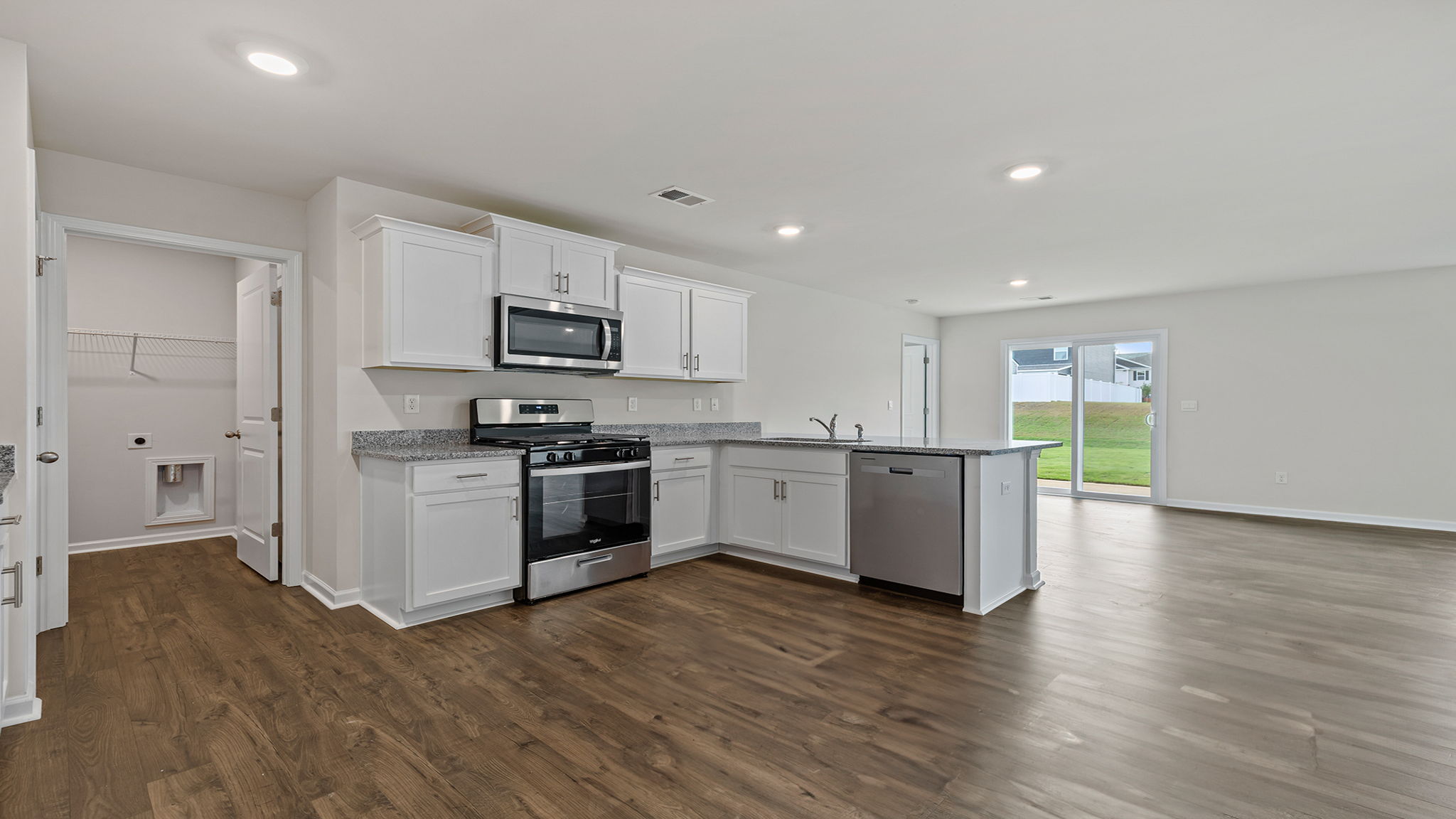 Kitchen with cabinets and windows.