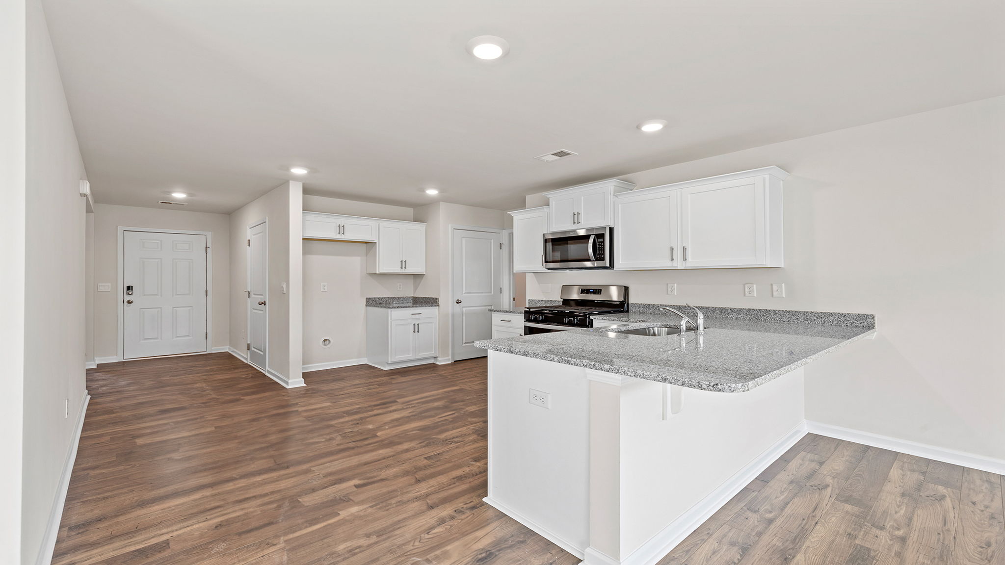 Kitchen with cabinets and windows.