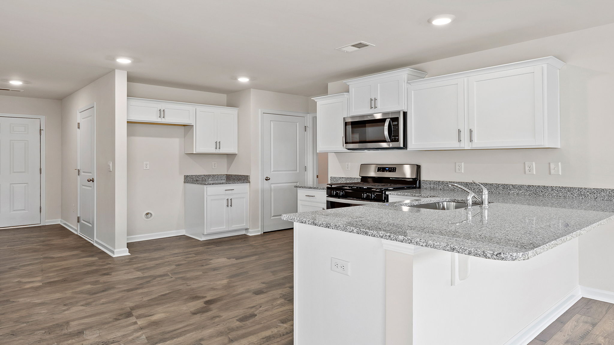 Kitchen with cabinets and windows.