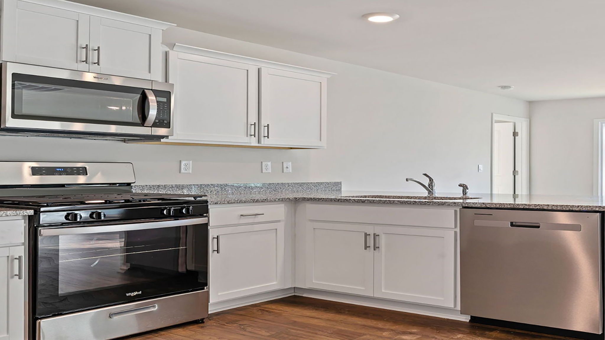 Kitchen with cabinets and windows.