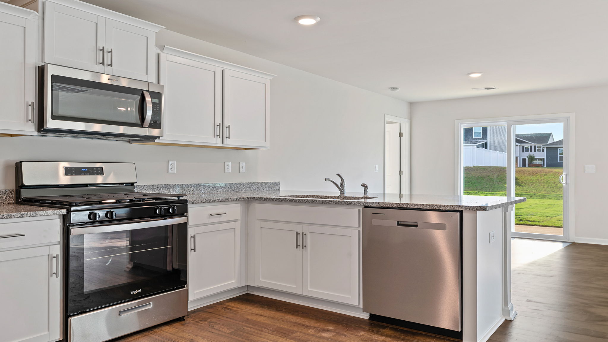 Kitchen with cabinets and window.