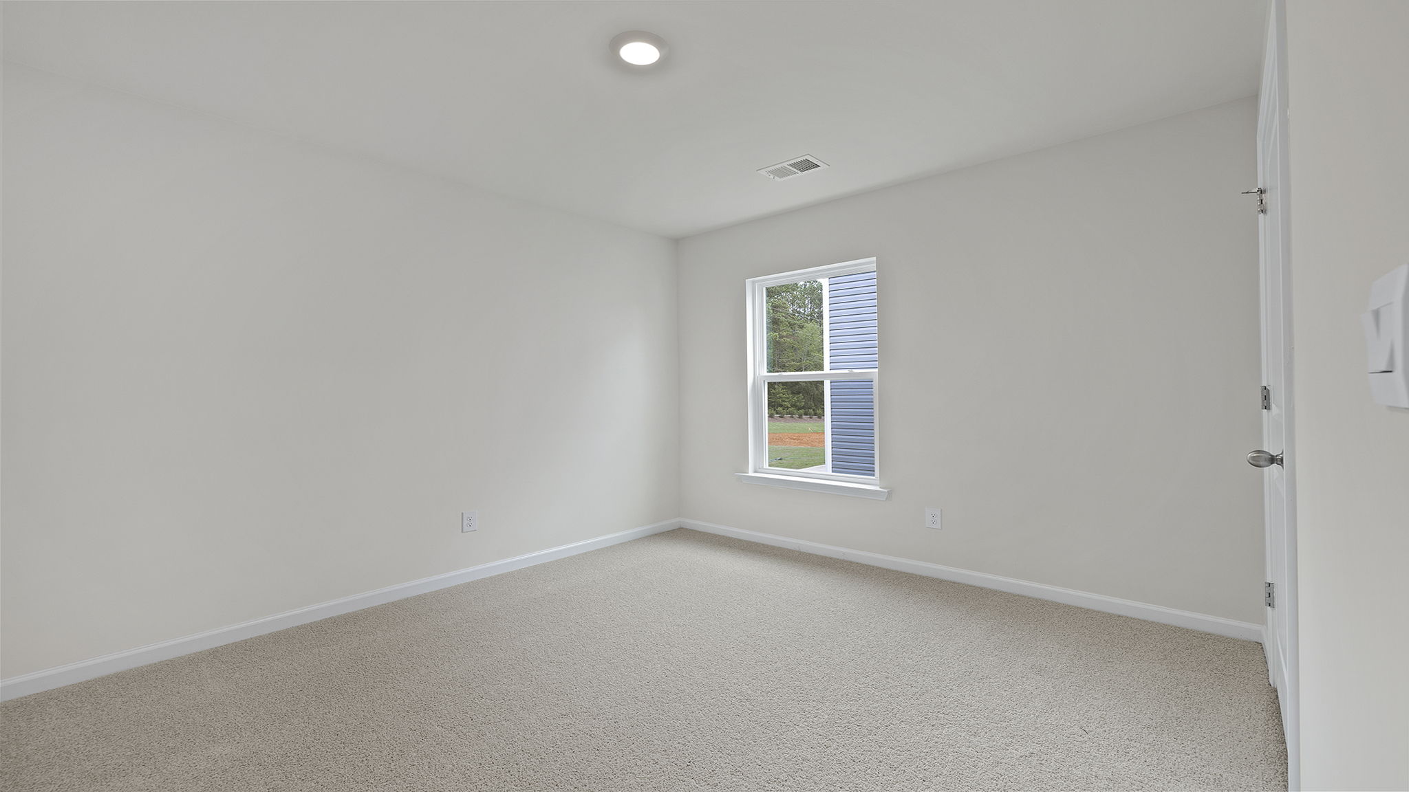 Bedroom with window and carpet.