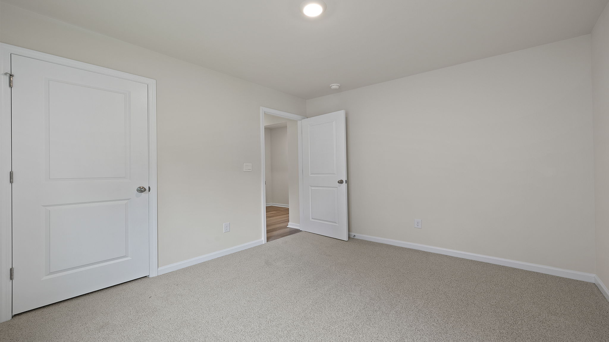 Bedroom with window and carpet.
