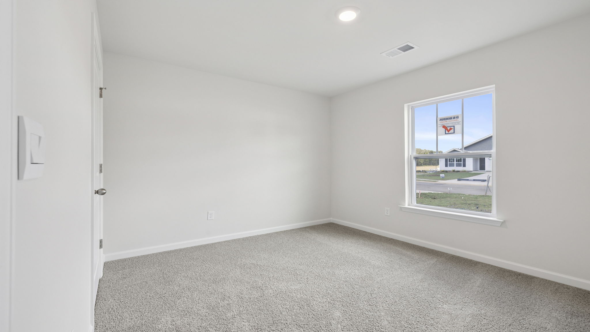Bedroom with window and carpet.