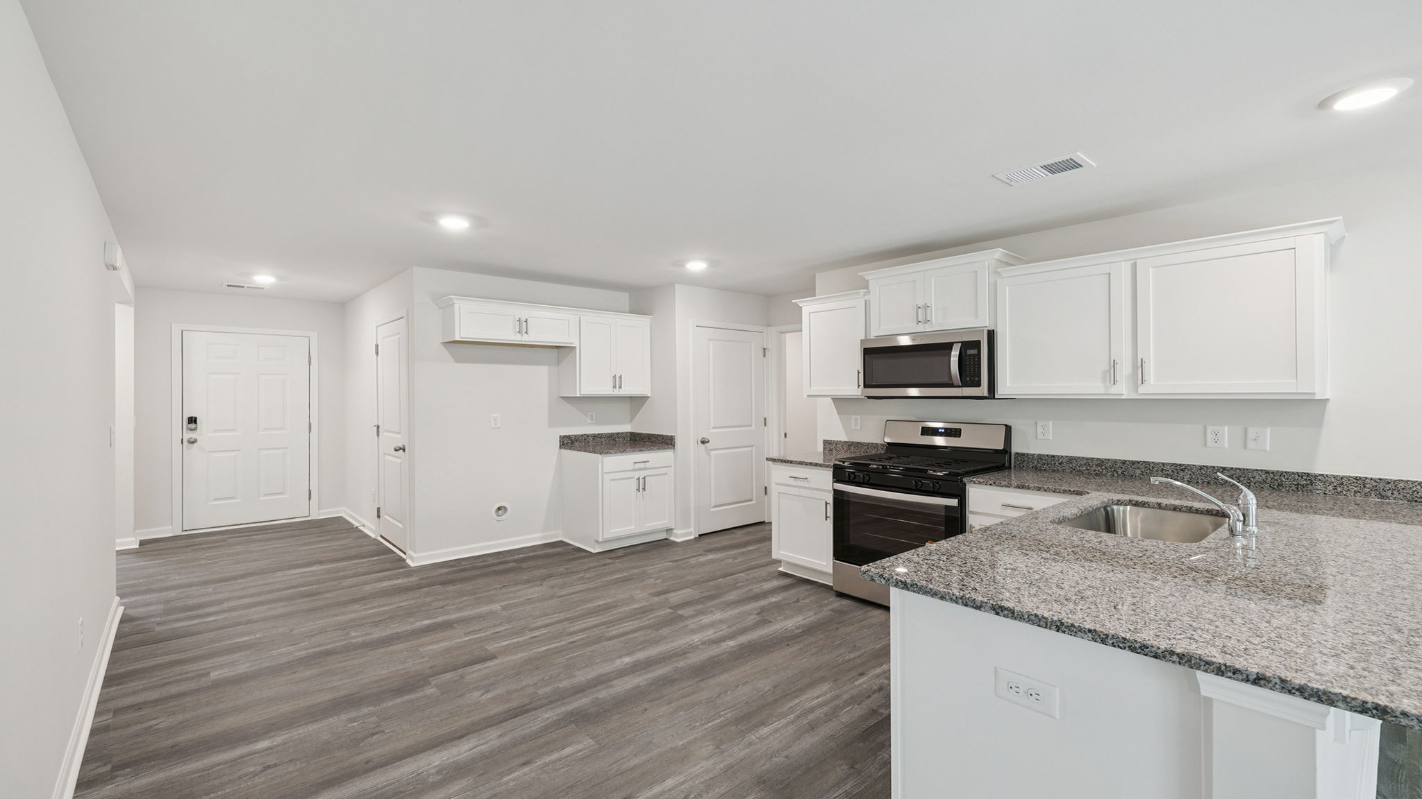View of kitchen and hallway to entrance.