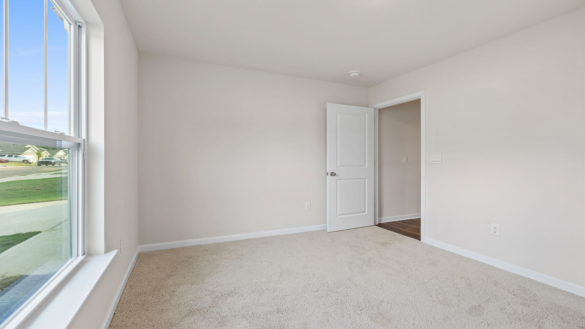 Bedroom with carpet and window.