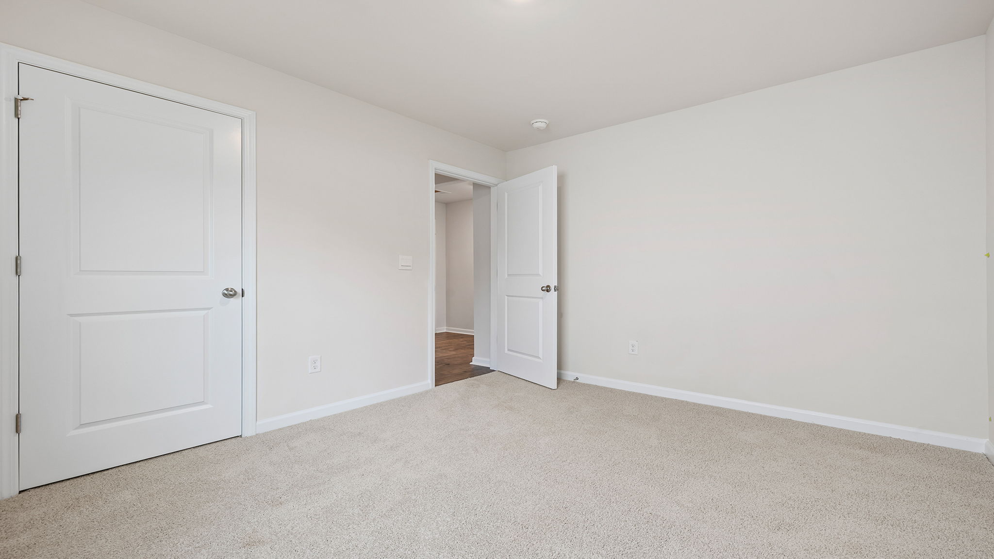 Bedroom with carpet and window.