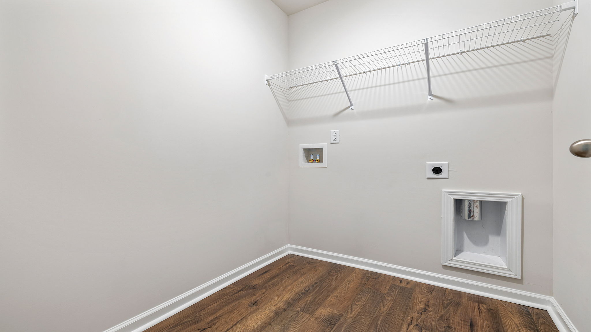 Laundry room with shelf.
