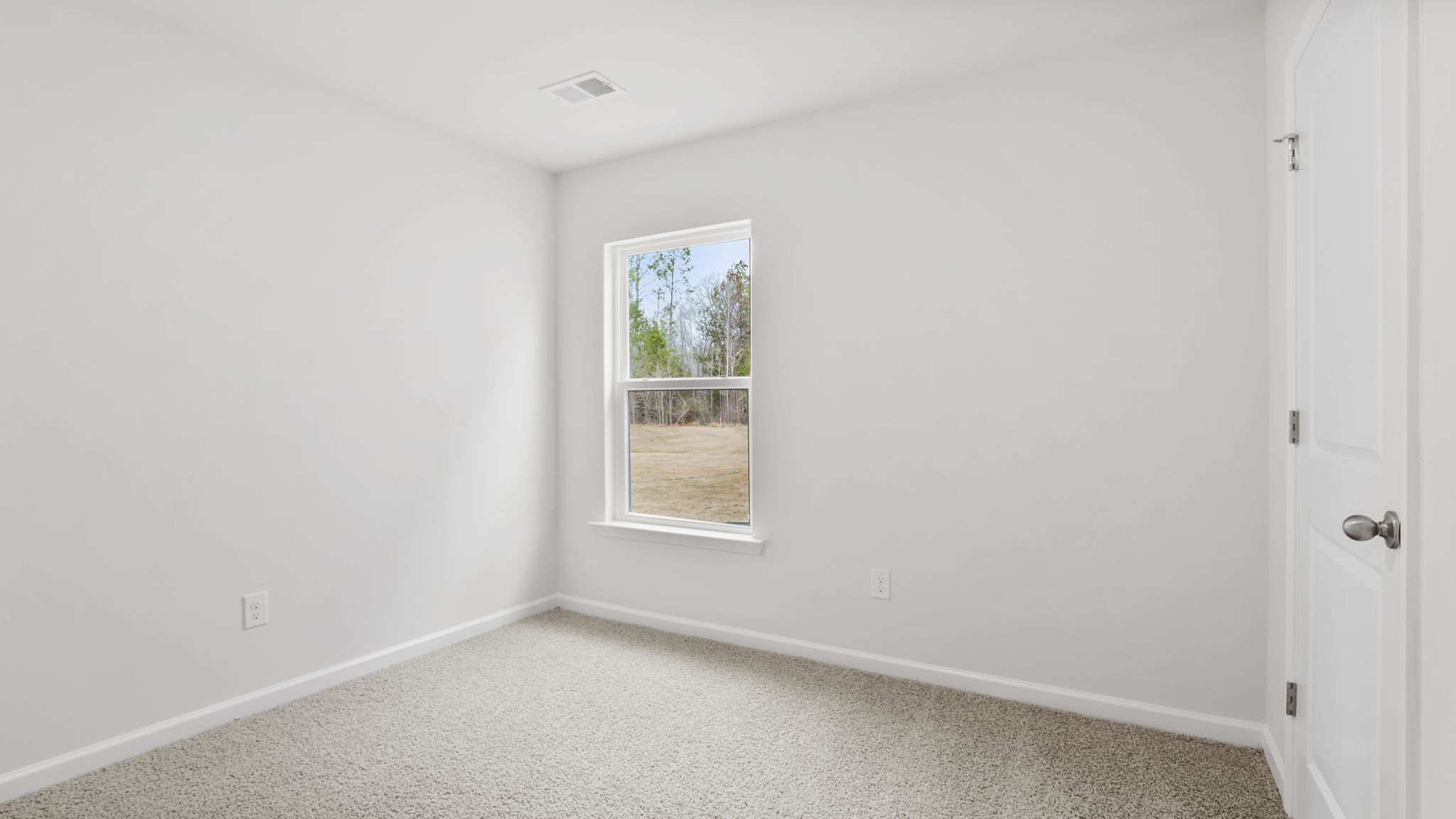 Bedroom with carpet and windows.
