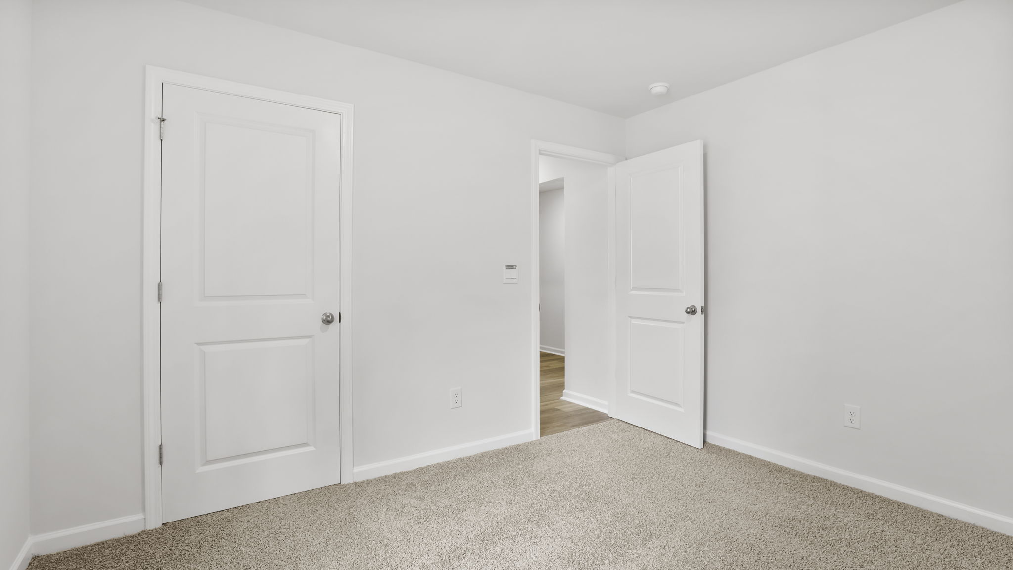 Bedroom with carpet and windows.
