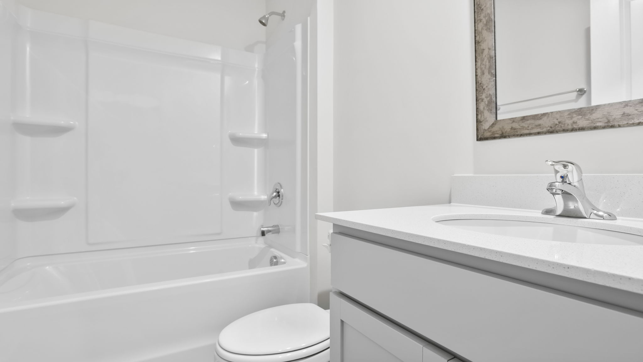 Hall bathroom with vanity and combination shower / tub.