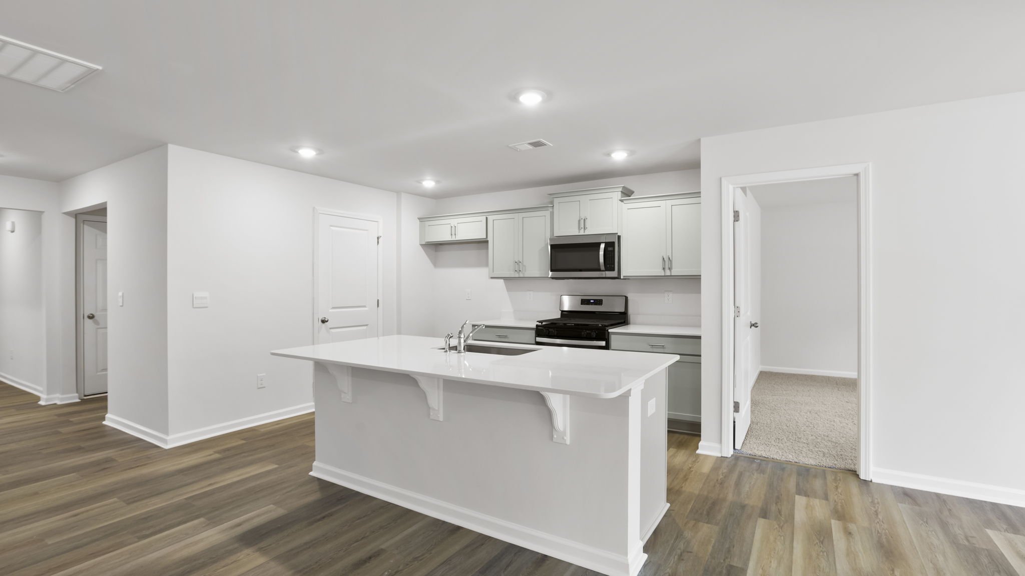 Kitchen with island and recessed lighting.