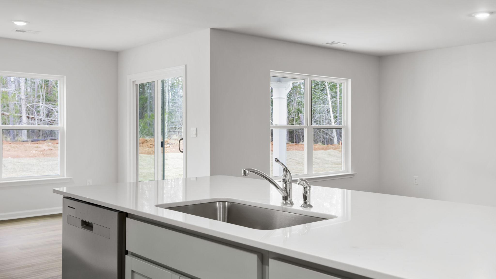 Kitchen island hosts sink and dishwasher.