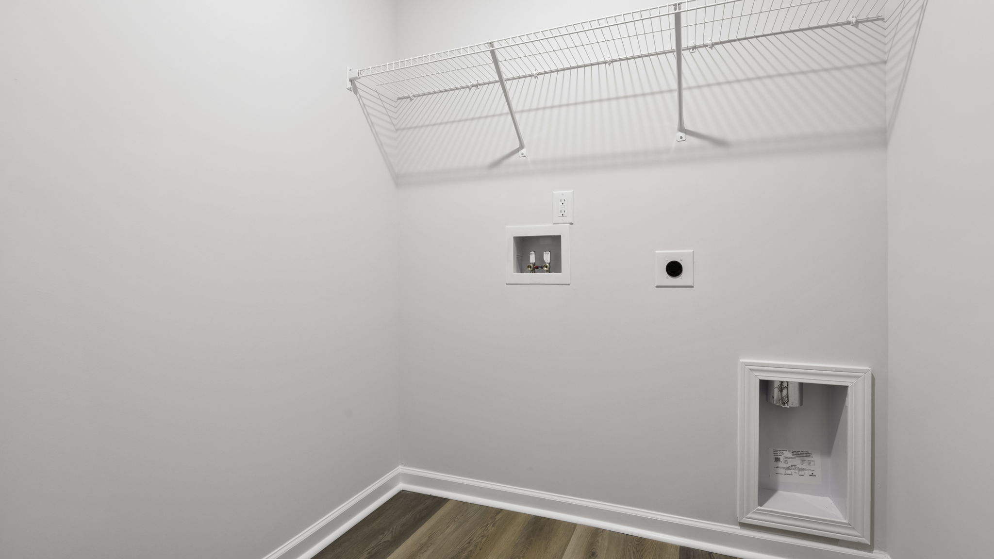 Walk-in laundry room with shelving.