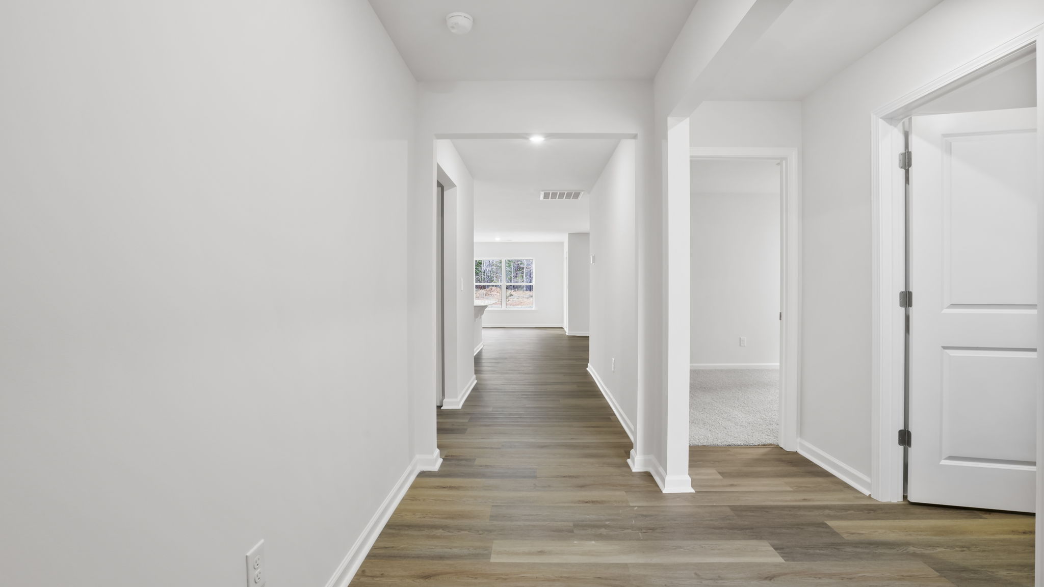 View of hallway and entrances to a bedroom and hall bathroom.